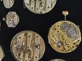 many different types of watches on a black surface