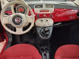 dashboard of a small car with red leather seats and a steering wheel