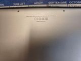 a close up of a laptop screen with a clock on it