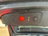 a close up of a car door with a red button