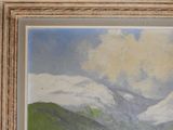 a picture of a painting of a mountain range in a frame