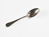a spoon that is sitting on a white surface