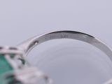 an image of a close up of a ring with a green stone