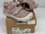 baby ' s shoes in a box on a white surface