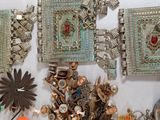 a lot of jewelry on a table with a white background