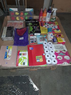 a table full of school supplies and supplies on the floor