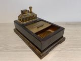 a small wooden box with a train on top of it
