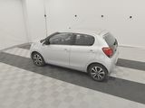 a picture of a small white car parked in a garage
