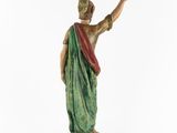 a statue of a woman in a green and red dress