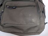a gray backpack with a zipper on the front