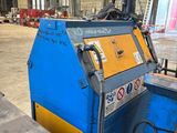 a close up of a machine in a warehouse with a lot of machinery
