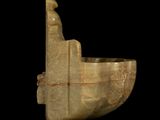 a stone sculpture of a boat on a black background