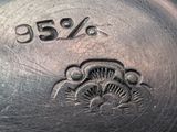a close up of a silver plate with the number 35 % engraved on it