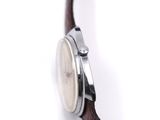 a close up of a watch on a white surface