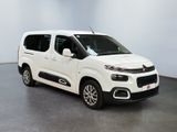 the white van is parked in a room with a gray floor