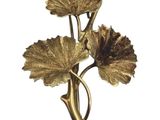 gold plated flower brooch with leaves on a white background
