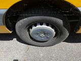 a person taking a picture of a car tire