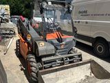an image of a forklift parked in front of a building