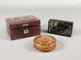 two small wooden boxes and a small wooden box on a white surface