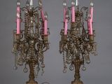 une paire de chandeliers anciens en laiton avec des bougies roses