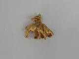 an image of a gold elephant charm on a white surface