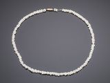 a white pearl necklace with a gold clasp