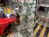 a display case in the middle of a store filled with items