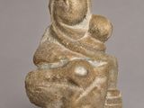 a statue of a woman holding a child on her lap
