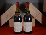 two bottles of wine sitting next to each other on a table