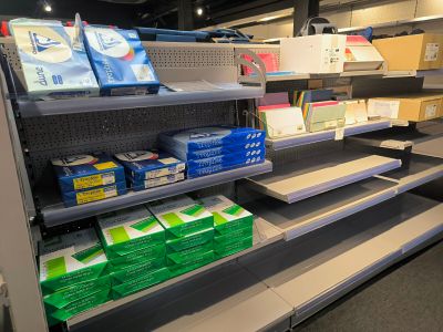 many boxes of toilet paper on the shelves in the store
