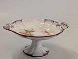 a white bowl with a purple and white design on it