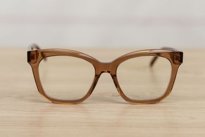 glasses on a wooden table with a white wall in the background