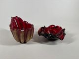 pair of red and gold glass bowls with a ladybug in the center