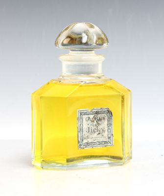 an image of a bottle of perfume sitting on top of a table