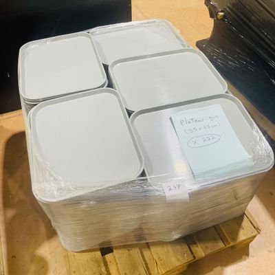 a stack of plastic containers sitting on a pallet