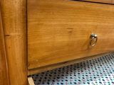 a wooden dresser with a drawer on top of it