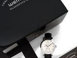 a black box with a watch inside of it on a table