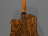 an acoustic guitar with a wooden back and neck