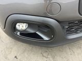 a close up of a car ' s front bumper with a light on