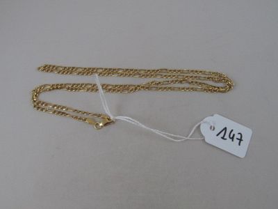 a close up of a gold chain with a tag on it