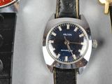 a watch that is sitting on a table with other watches