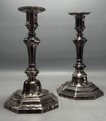 pair of silver candlesticks on a white background