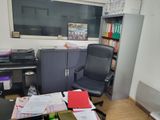 a desk with a computer and a chair in a room