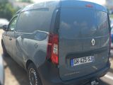 a grey van that is parked on the side of the road