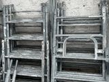 a lot of ladders that are leaning against a wall