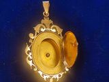 a gold locke with a yellow stone in it on a blue surface