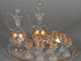 bottles and glasses on a tray on a table with a gray background