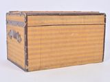a small wooden box with a handle on a white surface