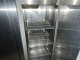 an open refrigerator in the corner of a room