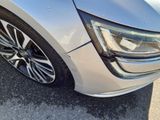 a close up of a car ' s headlight and the front end of the car